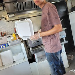 a man preparing food in a commercial kitchen