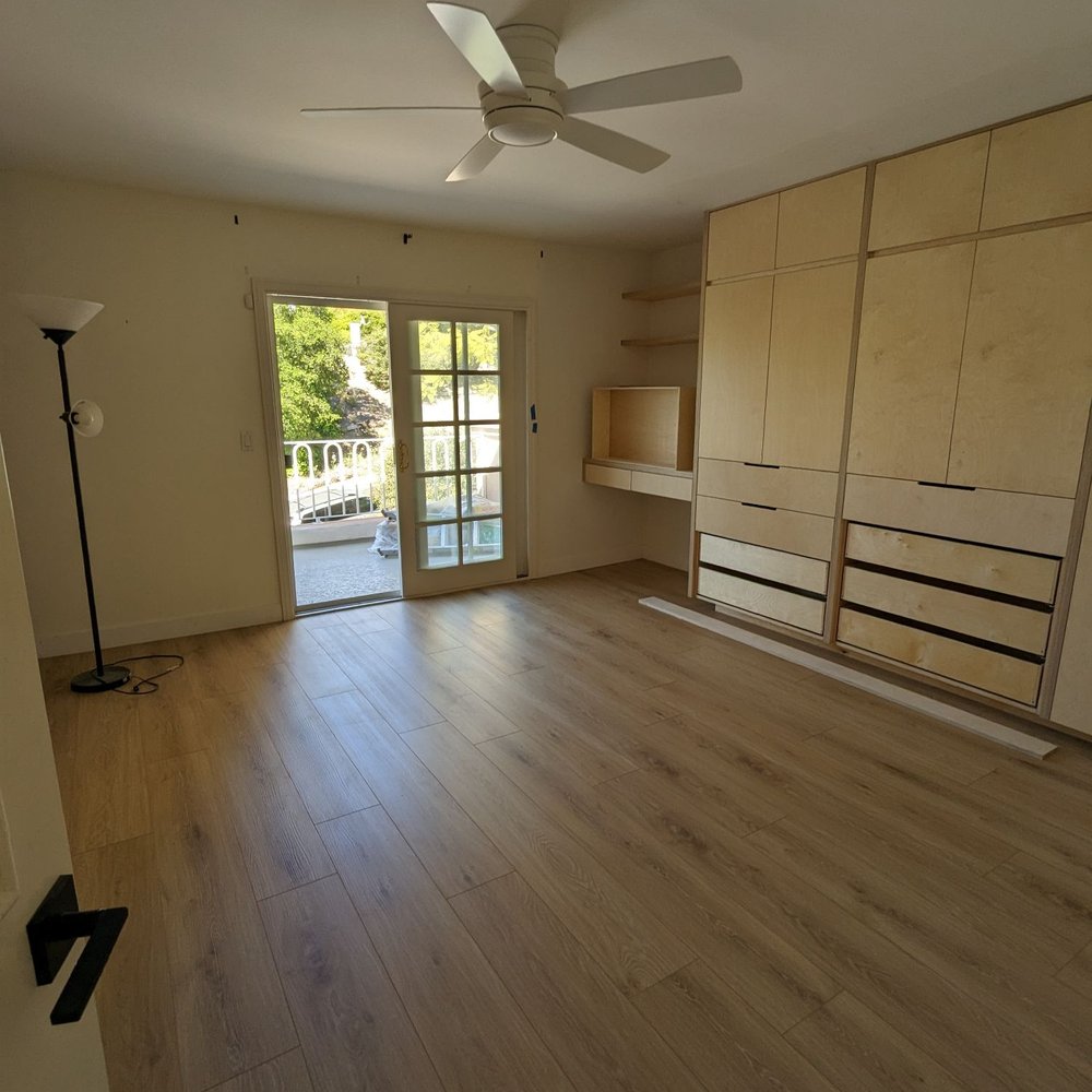 Gonzalez Floor Installations - a living room with a ceiling fan - Flooring Near Me