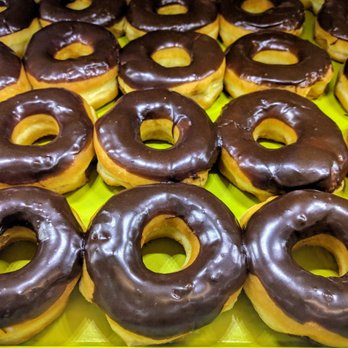 Florence Donuts - chocolate frosted donuts on a yellow tray - Donuts Near Me - Florence, Texas Florence Donuts - chocolate frosted donuts on a yellow tray - Donuts Near Me - Florence, Texas