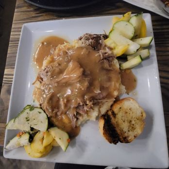 Frozen Pirogue - Pork over sweet corn grits - Cajun/Creole Near Me - Bossier City, Louisiana