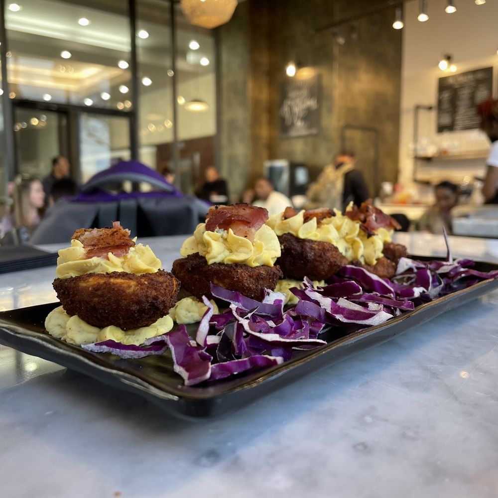Fried deviled eggs topped with bacon Fried deviled eggs topped with bacon