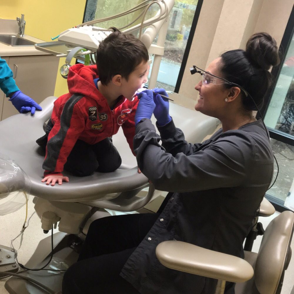 Dimples Pediatric Dental - Dr. Ro checking his teeth - Pediatric Dentists Near Me - Folsom, California Dimples Pediatric Dental - Dr. Ro checking his teeth - Pediatric Dentists Near Me - Folsom, California