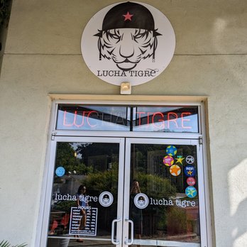 Lucha Tigre - Outside. Storefront. Entrance and business hours. Located in the Midtown Market shopping center. - Asian Fusion Near Me - Chapel Hill, North Carolina
