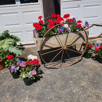 Wade's Vegetables - a wagon wheel with flowers in it - Farmers Market Near Me - Bloomfield, Connecticut