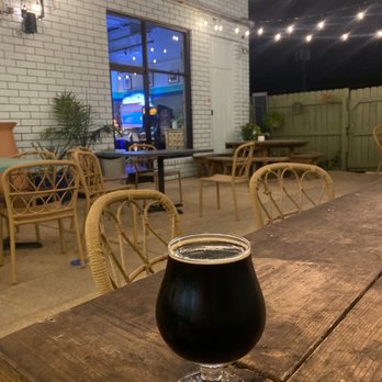 Odyssey Bottle Shop - a glass of beer on a table - Beer Bar Near Me - Charleston, South Carolina