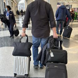 American Airlines - My bag on left silver is the smallest rolling luggage ... it's rare there is anything this tiny where my handbag is bigger than the luggage