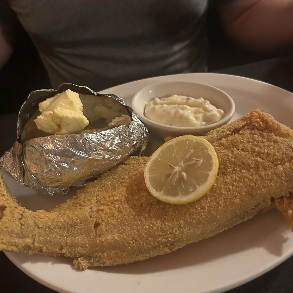 Pats Steakhouse - Fried catfish (large) with a baked potato and tartar sauce - Sports Bars Near Me - Rushville, Missouri Pats Steakhouse - Fried catfish (large) with a baked potato and tartar sauce - Sports Bars Near Me - Rushville, Missouri