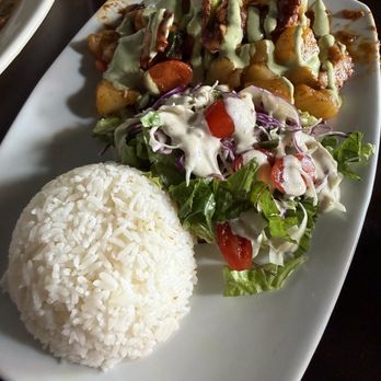 Peruvian Corner Hawaii - Octopus with potatoes topped with a creamy cilantro sauce served with rice and salad. - Peruvian Near Me - Waialua, Hawaii Peruvian Corner Hawaii - Octopus with potatoes topped with a creamy cilantro sauce served with rice and salad. - Peruvian Near Me - Waialua, Hawaii