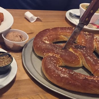 Green Bay Distillery - HUGE pretzel appetizer (served on a pizza tray) w/ cheese sauce, mustard, cinnamon butter.   So big, 4 of us couldn't finish it! - New American Near Me - Green Bay, Wisconsin