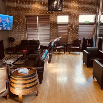 Lefty’s Lounge - a living room with brick walls and a television - Cigar Bars Near Me - Lodi, California