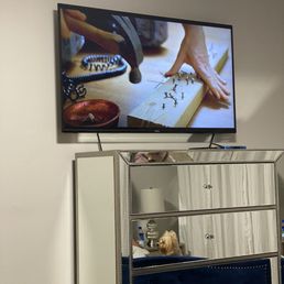 My bedroom TV, perfectly placed above my dresser per my request!