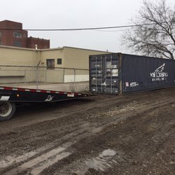 14th Street Storage - They're unloading another container.