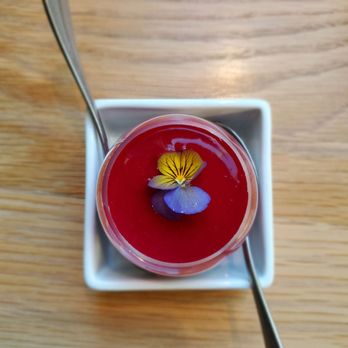 L'Experience Paris - Bellevue - Close up of chocolate raspberry mousse with edible flowers - Bakeries Near Me - Bellevue, Washington