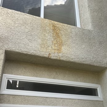 Squirts Pro Wash - Before photo: Rust stain on exterior stucco - Pressure Washers Near Me