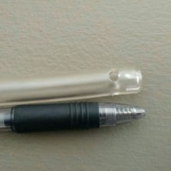 Spa Lavage - This photo shows the clean water inflow nozzle compared to an average pen. The actual outer diameter of the nozzle is 3/8 inch.