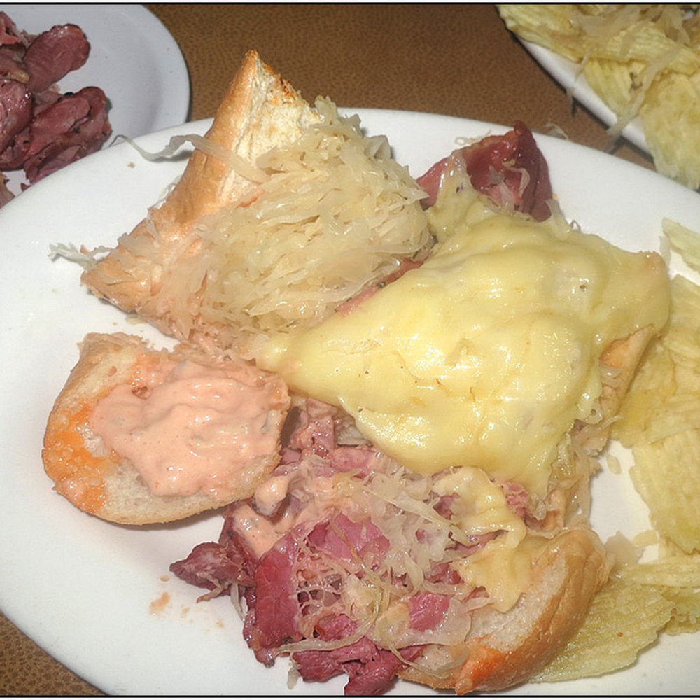 Half eaten Pastrami Reuben