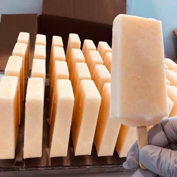 All We Need Farm - a person holding a block of cheese - Farmers Market Near Me - Needville, Texas