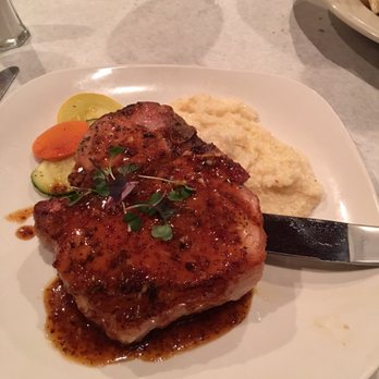 Vintage On 5th - Porterhouse porkchop with cheese grits and veggies - New American Near Me - Crystal River, Florida Vintage On 5th - Porterhouse porkchop with cheese grits and veggies - New American Near Me - Crystal River, Florida