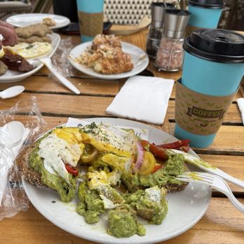 The Pantry - Smashed avocado toast with fried egg. Vanilla latte and coconut crescent... yum! - Breakfast & Brunch Near Me - Laguna Beach, California