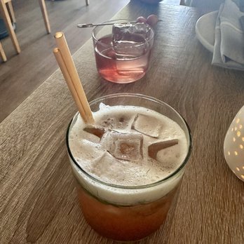 Driftwood - Grand Fenelley mocktail in the front, Blueberry Skies cocktail in the back - Seafood Near Me - Seattle, Washington Driftwood - Grand Fenelley mocktail in the front, Blueberry Skies cocktail in the back - Seafood Near Me - Seattle, Washington