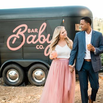 Bar Baby Co. - a man and woman walking in front of a food truck - Bartenders Near Me Bar Baby Co. - a man and woman walking in front of a food truck - Bartenders Near Me