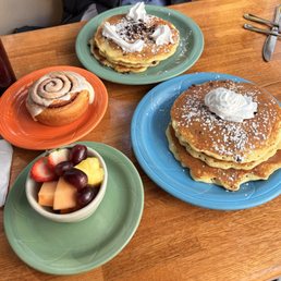 Chocolate chip pancakes, pancakes, cinnamon roll, fruit bowl side