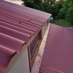 Region Roofing - edges cut in an attempt to correct installation error. lower portion is trim pulled into place bending panel instead of installing correctly
