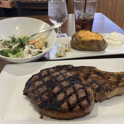 HM’s Steakhouse - Bone in Ribeye (Medium Rare) with Loaded Baked Potato and a side salad