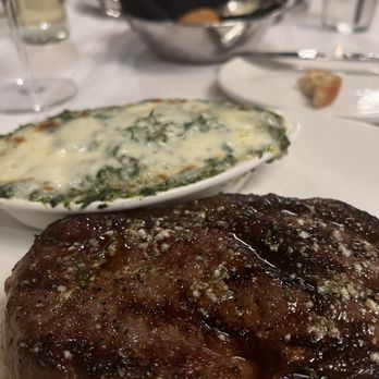 Stoney River - Prime rib, creamed spinach with a house roll in the background. - Steakhouses Near Me - Annapolis, Maryland Stoney River - Prime rib, creamed spinach with a house roll in the background. - Steakhouses Near Me - Annapolis, Maryland