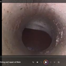 American Trenchless Technologies - Repaired connection at the Main with new liner in place over the old clay tile pipe.