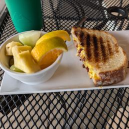 Sunrise on sourdough breakfast sandwich with fruit Sunrise on sourdough breakfast sandwich with fruit