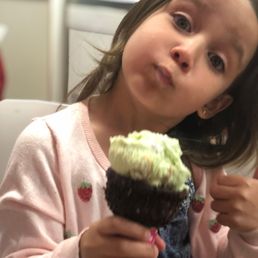 Grace savoring pistachio ice cream with almonds