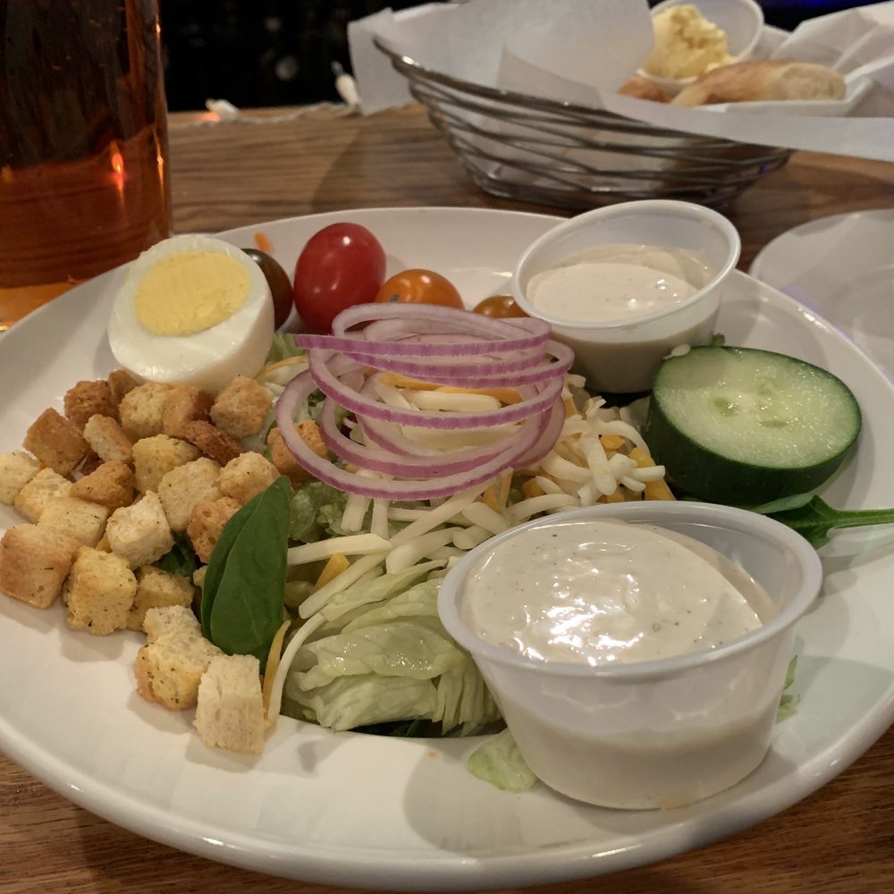 Brown Derby - House salad with blue cheese dressing and a variety of tomatoes. Note the soft rolls in the background - Steakhouses Near Me - Middleburg, Ohio