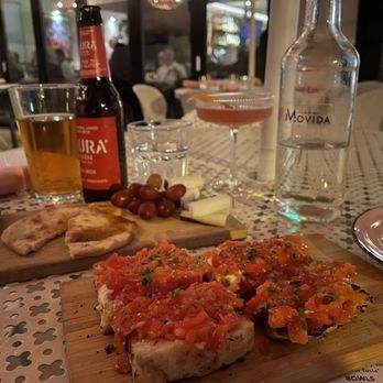 Movida - Drinks: NA Cosmopolitan Dora Damm Tapas: pan con tomate, drunk goat - Spanish Near Me - Milwaukee, Wisconsin Movida - Drinks: NA Cosmopolitan Dora Damm Tapas: pan con tomate, drunk goat - Spanish Near Me - Milwaukee, Wisconsin