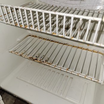 Americas Best Value Inn & Suites Madera - Inside of in-room refrigeration. Covered in rust and food stains/reside spillage. - Hotels Near Me - Madera, California Americas Best Value Inn & Suites Madera - Inside of in-room refrigeration. Covered in rust and food stains/reside spillage. - Hotels Near Me - Madera, California