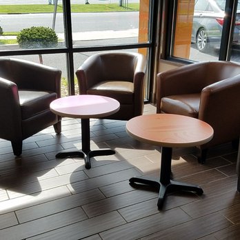 Dunkin' -  three chairs and a table in front of a window - Coffee & Tea Near Me - Millville, New Jersey