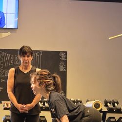 Everybitfit Scottsdale trainer teaching proper form for an exercise with her client