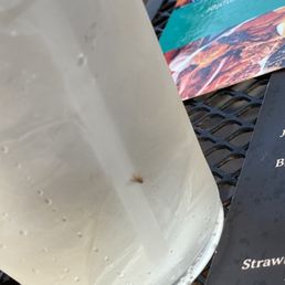 a drink and a menu on a table a drink and a menu on a table