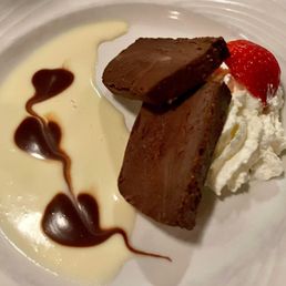 a chocolate dessert with whipped cream and strawberries a chocolate dessert with whipped cream and strawberries