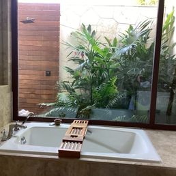 this is the bath room there is a tub and out door shower and indoor shower