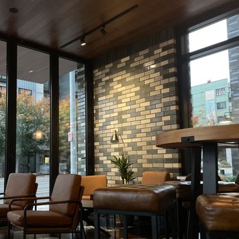 Café Hagen - a table and chairs in front of a large window - Cafes Near Me - Seattle, Washington