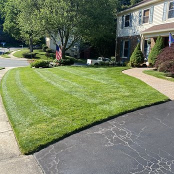 Miranda Landscaping - a freshly mowed lawn in front of a house - Landscaping Near Me