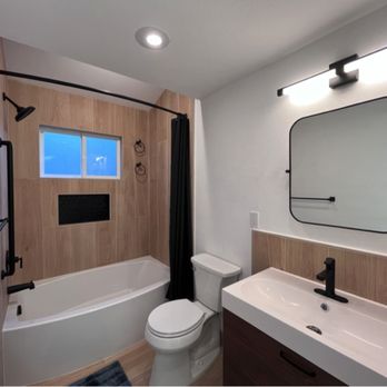 One Hand Construction - a bathroom with a sink, toilet, and bathtub - General Contractors Near Me