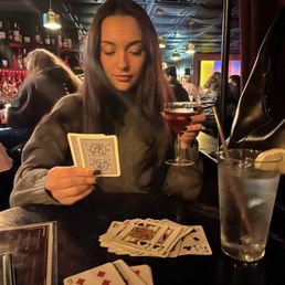 Playing cards and drinking a cocktail Playing cards and drinking a cocktail