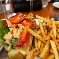 Rizzuto's Oyster Bar & Restaurant - Warm lobster roll on toasted butter brioche roll with drawn butter and yummy slaw.