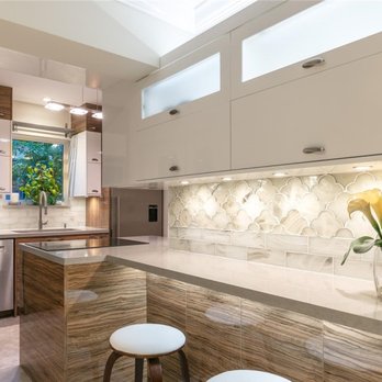 Unique Construction - Custom, Italian-finish kitchen remodel featuring two-tone cabinet design & backsplash tile design and accented by under-cabinet LED lighting - General Contractors Near Me - Miami, Florida