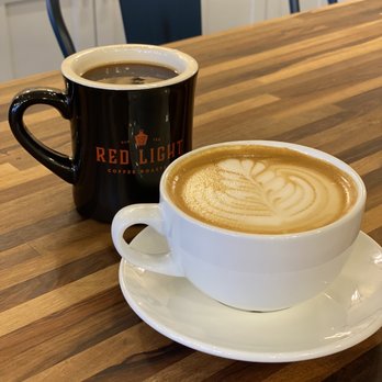 Red Light Coffee Roasters - Delicious Americano & Oat milk latte for here. Latte art by the talented Sadie! - Coffee Roasteries Near Me - Galveston, Texas Red Light Coffee Roasters - Delicious Americano & Oat milk latte for here. Latte art by the talented Sadie! - Coffee Roasteries Near Me - Galveston, Texas