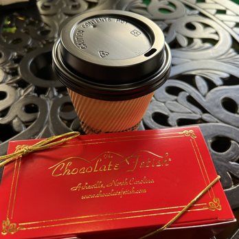 The Chocolate Fetish - a cup of coffee on a table - Chocolatiers & Shops Near Me - Asheville, North Carolina The Chocolate Fetish - a cup of coffee on a table - Chocolatiers & Shops Near Me - Asheville, North Carolina