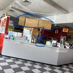 C & L Burger Bar - The menu was supposed to be on that bored i'm assuming but instead it's a paper copy with a tiny light on it