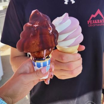 Ice Cream Delights - a man holding two ice cream cones - Ice Cream & Frozen Yogurt Near Me - Lincoln, New Hampshire